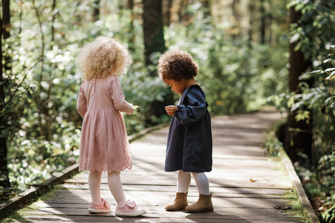 Two girls walking in the forest